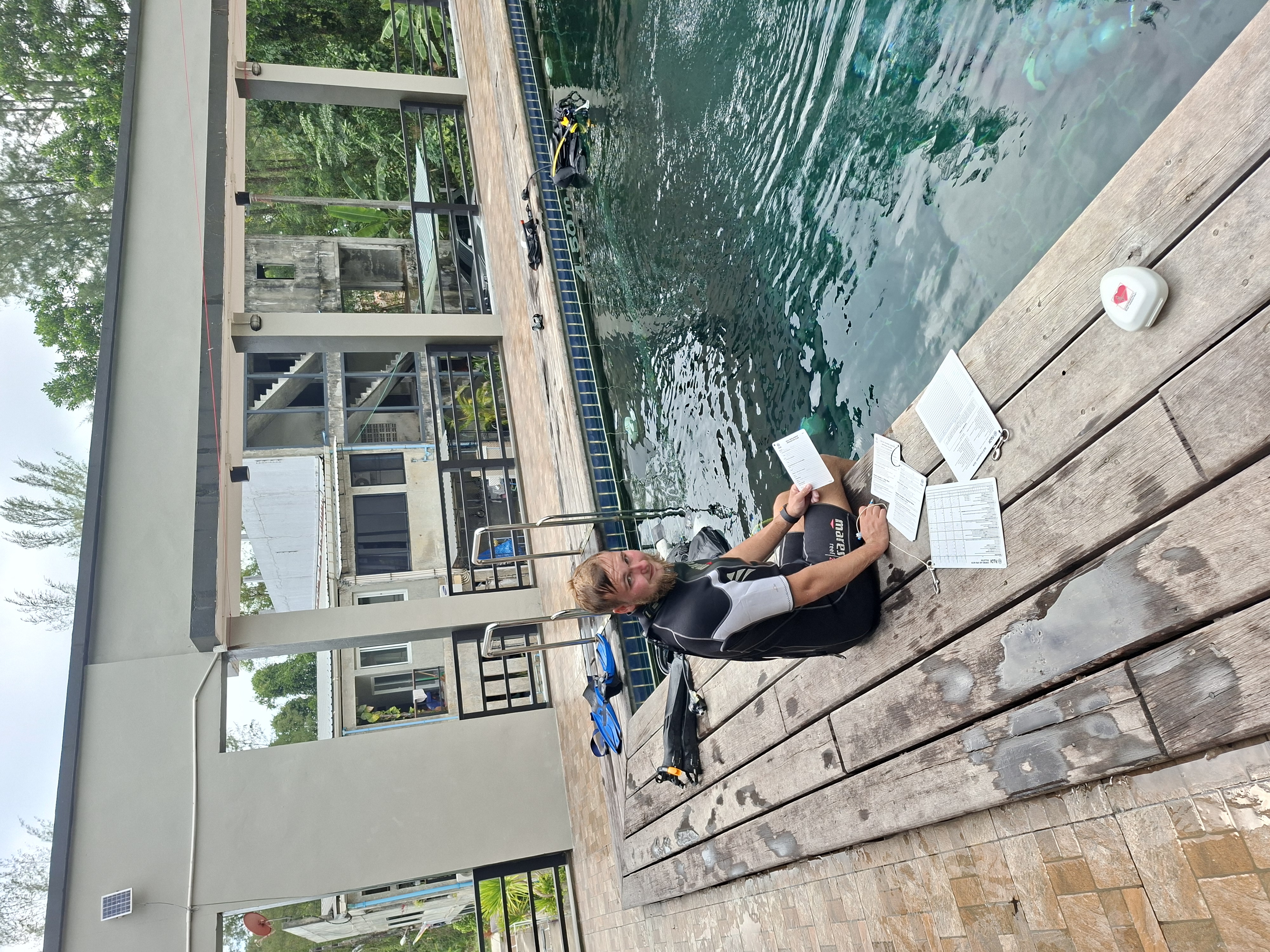 PADI IDC candidate completing assessment work beside the training pool