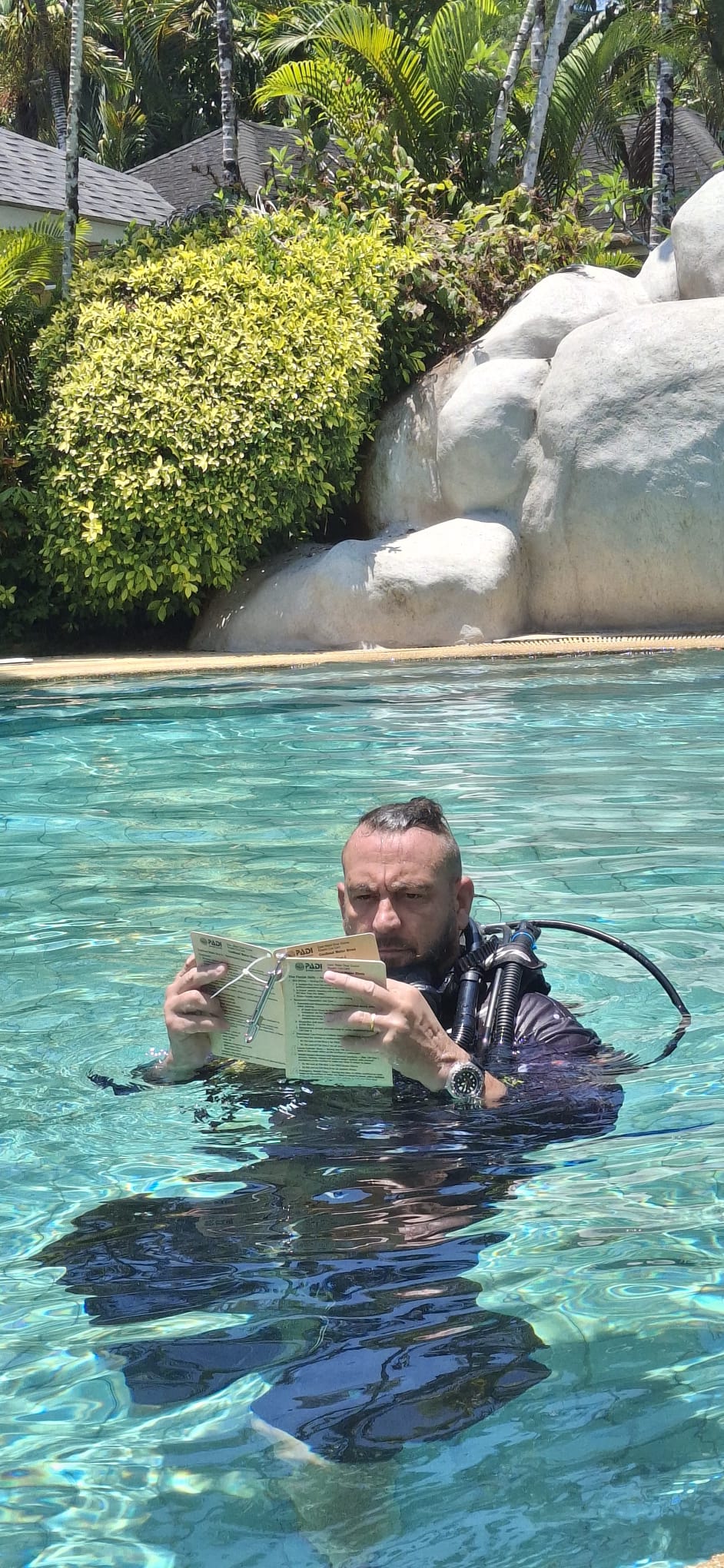 Instructor demonstrating a regulator skill during confined-water IDC training